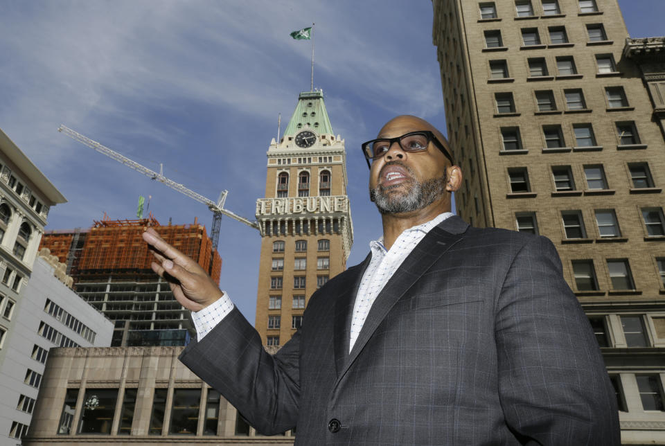 In this July 2, 2019, photo, Martin Reynolds, co-executive director of the Maynard Institute, speaks during an interview outside the Tribune Tower, the former home of the Oakland Tribune newspaper in Oakland, Calif. "There was a time when newspapers were so powerful and so meaningful and so influential to the community," said Reynolds, who started as an intern at the Oakland Tribune and became editor in 2008. "To have lost that is a shame." (AP Photo/Eric Risberg)