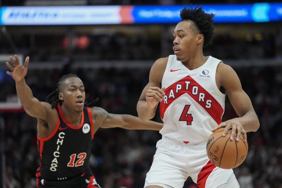 Chicago Bulls guard Ayo Dosunmu (12) guards Toronto Raptors forward Scottie Barnes (4) during the second half of an NBA basketball game Tuesday, Jan. 30, 2024, in Chicago. Toronto won 118-107. (AP Photo/Erin Hooley)