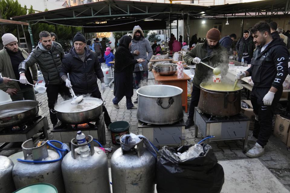 FILE Volunteers cook for Syrians at a shelter in Antakya, southeastern Turkey, Friday, Feb. 10, 2023. For Syrians and Ukrainians fleeing the violence back home, the earthquake that struck in Turkey and Syria is but the latest tragedy. The U.N. says Turkey hosts about 3.6 million Syrians who fled their country’s 12-year civil war, along with close to 320,000 people escaping hardships from other countries. (AP Photo/Hussein Malla, File)