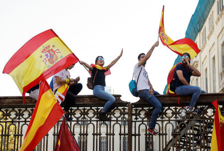People wave Spanish flags during a pro-union demonstration organised by the Catalan Civil Society organisation in Barcelona, Spain, October 8, 2017. REUTERS/Eric Gaillard
