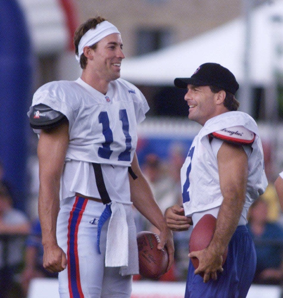 They were smiling here, but Rob Johnson and Doug Flutie were bitter rivals during their time together with the Bills from 1998-2000.