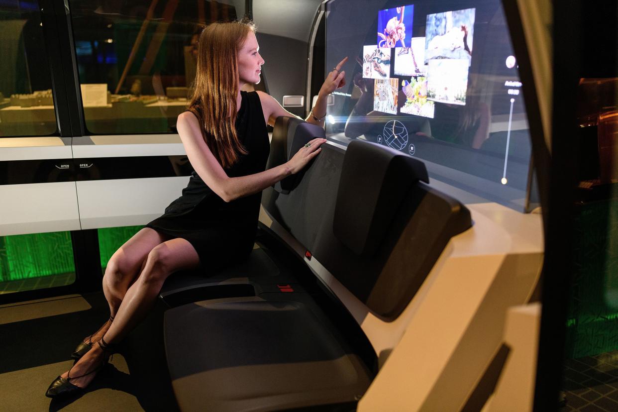 a gallery assistant sits inside the "sedric" volkswagen driverless concept car during the press launch of the new exhibition; "the future starts here" at victoria and albert museum on may 9, 2018 in london, england