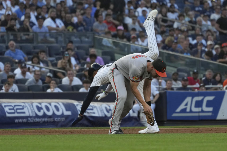 New York Yankees' Juan Soto and Baltimore Orioles third baseman Jordan Westburg collide as Soto was forced out at third base during the first inning of a baseball game Tuesday, June 18, 2024, in New York. (AP Photo/Pamela Smith)