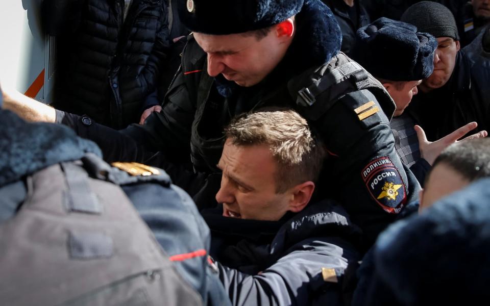 Police officers detain anti-corruption campaigner and opposition figure Alexei Navalny 