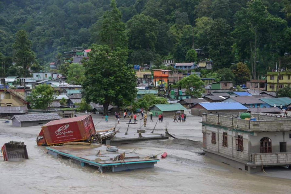 A vehicle that got washed away lies atop a submerged building after flash floods triggered by a sudden heavy rainfall swamped the Rangpo town in Sikkim, India, Thursday, Oct.5. 2023. The flooding took place along the Teesta River in the Lachen Valley of the north-eastern state, and was worsened when parts of a dam were washed away. (AP Photo/Prakash Adhikari)