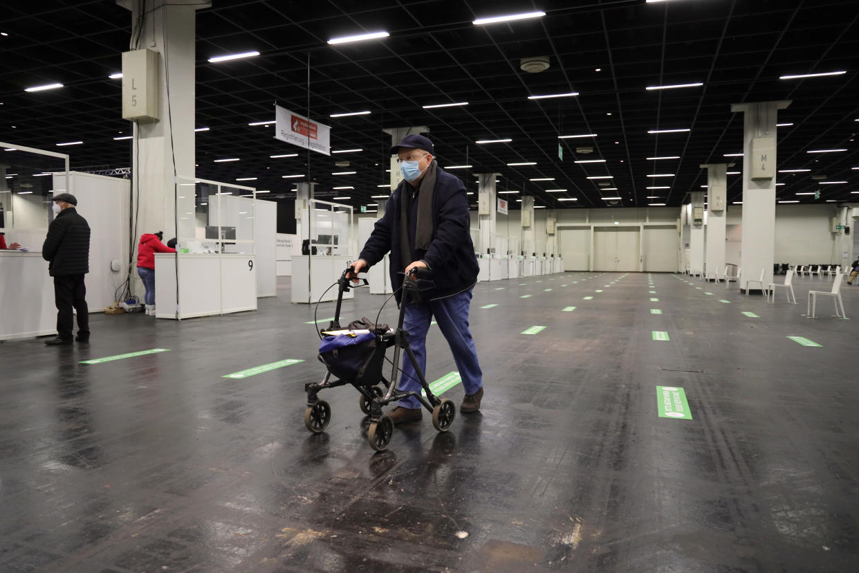 COLOGNE, GERMANY - FEBRUARY 08:  A senior citizen queues up to register and following up with a vaccination against COVID-19 at a vaccine center built in a hall of the Koeln Messe trade fair grounds during the second wave of the coronavirus pandemic on February 08, 2021 in Cologne, Germany. The 53 vaccine centers across North Rhine-Westphalia are opening their doors today to administer vaccines, mostly against people over 80 years old. Germany has experienced a hampered vaccine rollout due to production setbacks for all three of the vaccine so far approved in the European Union. (Photo by Andreas Rentz/Getty Images)