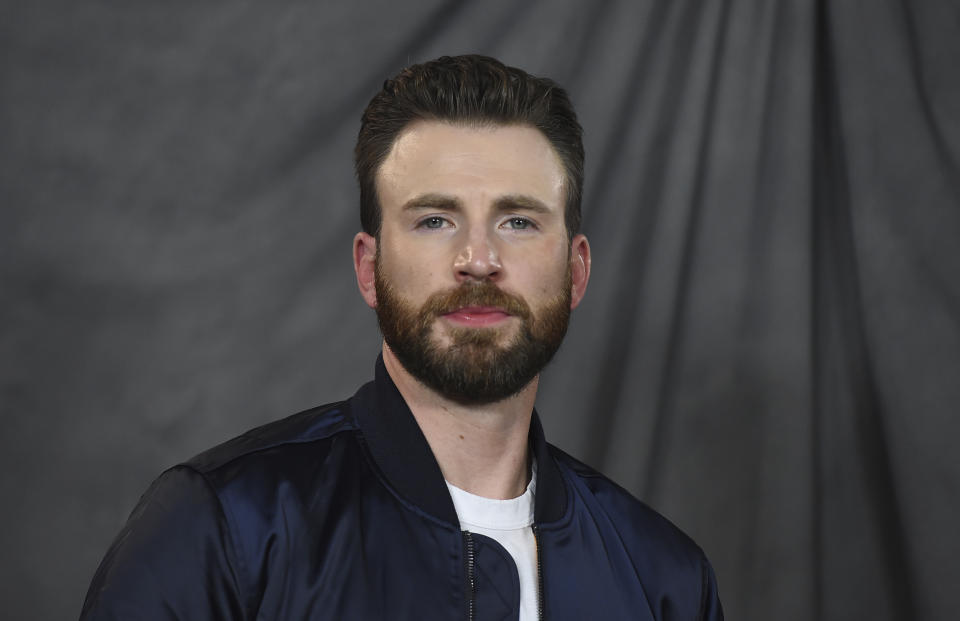 FILE - Chris Evans attends the "Knives Out" photo call at the Four Seasons Hotel on Nov. 15, 2019, in Los Angeles. The “Captain America” star has a new title — he's been named People magazine's Sexiest Man Alive. The selection was announced Monday night, Nov. 7, 2022, on Stephen Colbert's late night show and on the magazine's website. (Photo by Jordan Strauss/Invision/AP, File)