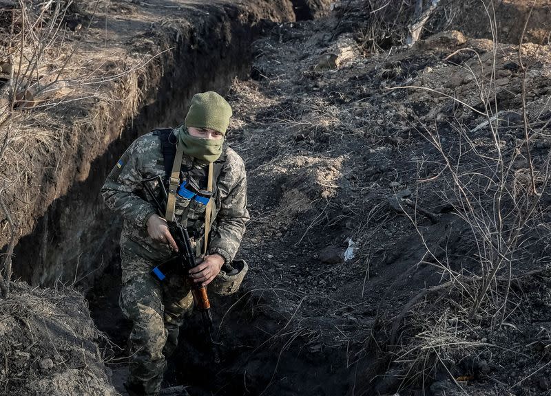 A serviceman is seen in a trench near the village of Zolote