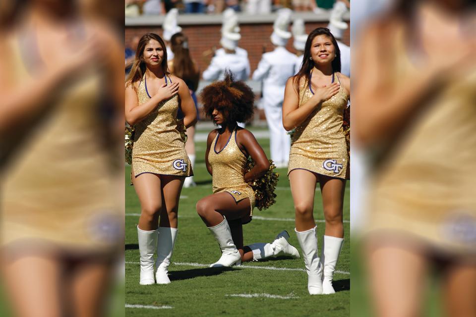 Raianna Brown, seen kneeling on the football field in a national anthem protest, is going viral for reposting a photo from that day over the weekend. (Photo: David J. Griffin/Icon Sportswire)