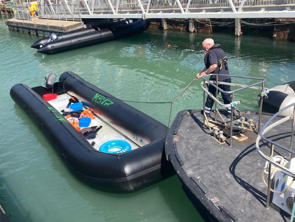 A small boat used by a group of people thought to be migrants is brought in to Dover, Kent, following a small boat incident in the Channel. (PA)