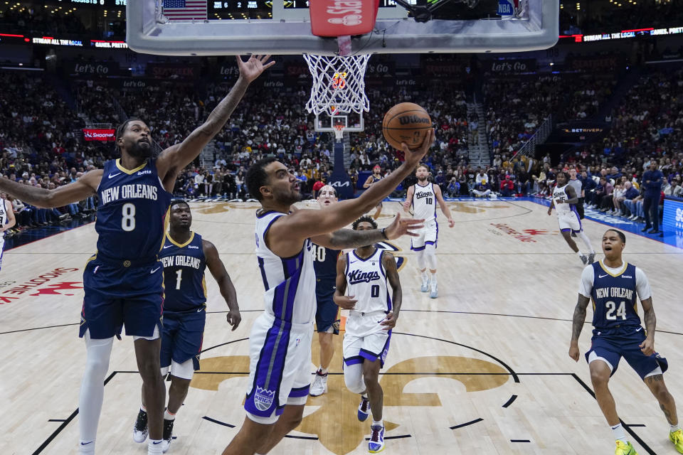 Sacramento Kings forward Trey Lyles goes to the basket against New Orleans Pelicans forward Naji Marshall (8) in the first half of an NBA basketball game in New Orleans, Wednesday, Nov. 22, 2023. (AP Photo/Gerald Herbert)