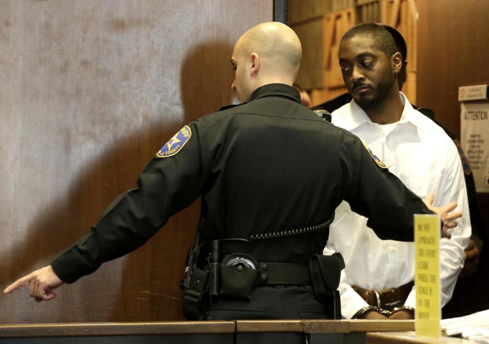 Basim Henry, 32, right, one of four accused in the Dec. 15, 2013, carjacking at The Mall at Short Hills, where Dustin Friedland, of Hoboken, was fatally shot as he returned with his wife to their vehicle, walks into the courtroom for an arraignment hearing at Essex County Superior Court, Wednesday, Jan. 8, 2014, in Newark, N.J. Hanif Thompson, 29, Karif Ford, 31, and Kevin Roberts, 33, were also charged during the morning arraignment. All four pleaded not guilty. Each has been charged with murder, felony murder, carjacking, conspiracy, possession of a weapon and possession of a weapon for unlawful purpose. (AP Photo/Julio Cortez)