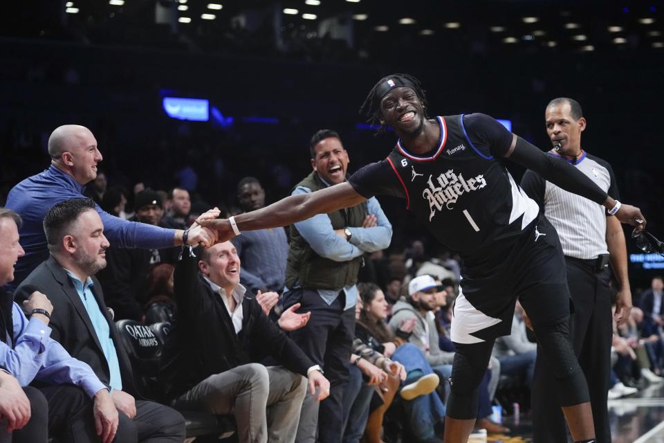 Los Angeles Clippers' Reggie Jackson (1) shakes hands with a Brooklyn Nets fan during the second half of an NBA basketball game, Monday, Feb. 6, 2023, in New York. The Clippers won 124-116. (AP Photo/Frank Franklin II)