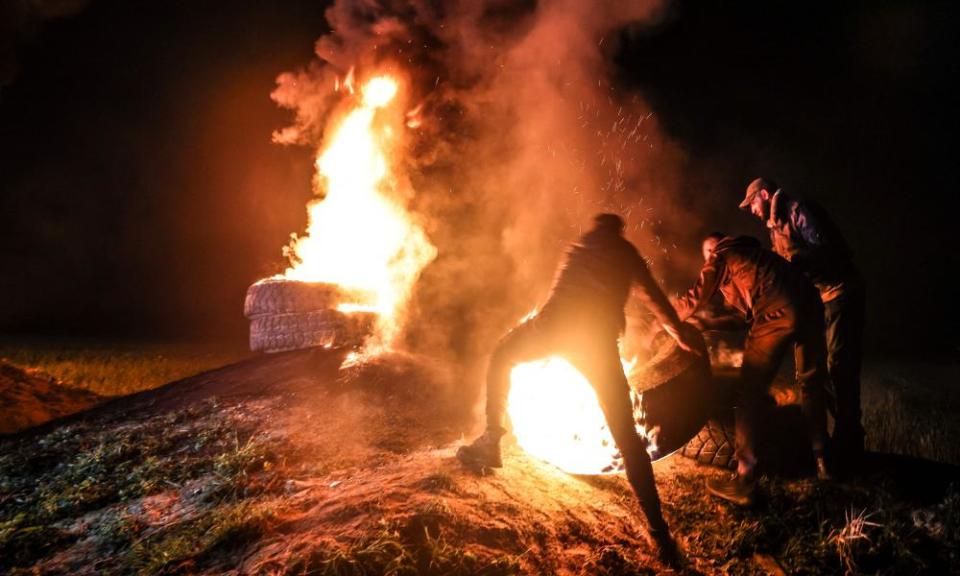 Palestinian youths burn tyres during a protest near the Israel-Gaza border on 26 February, the day Israel met with Arab leaders in Aqaba in Jordan.