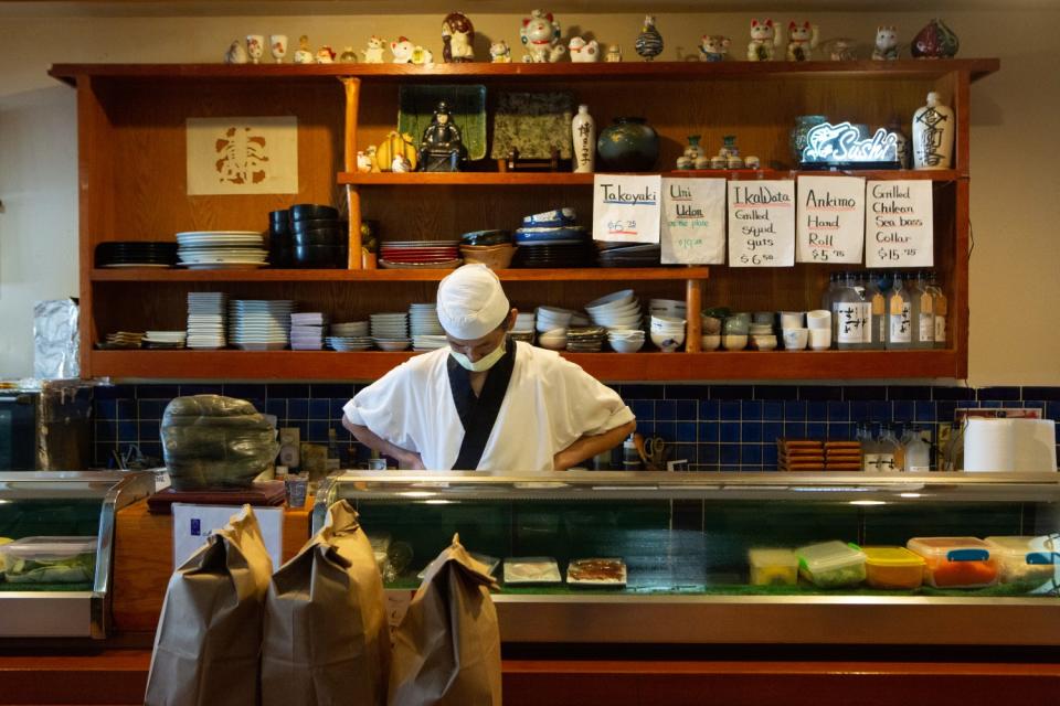 Kiyoto Nagasu, father of Olympic figure skater Mirai Nagasu, takes a moment after preparing lunches for medical workers at their restaurant Sushi Kiyosuzu in Arcadia.