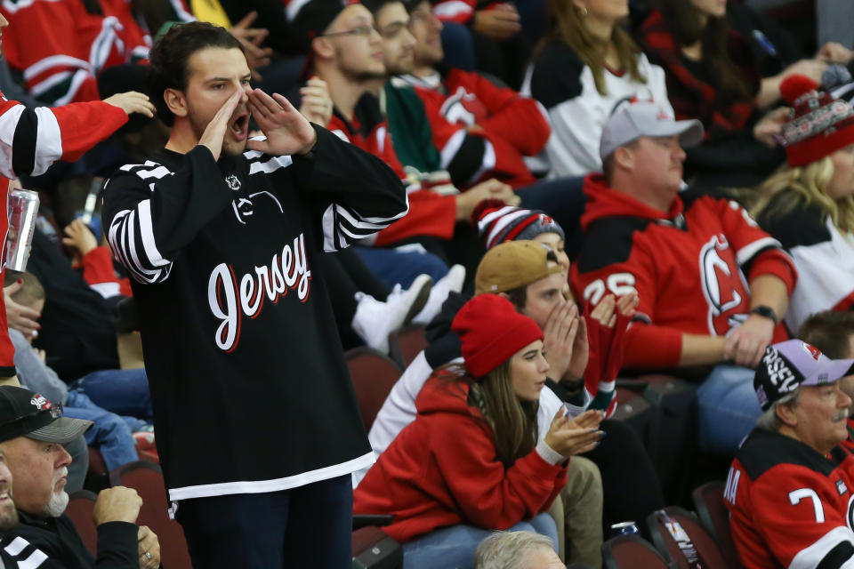 Nov 24, 2021; Newark, New Jersey; A fan cheers on the New Jersey Devils during the game against Minnesota Wild at Prudential Center. Photo: Tom Horak-USA TODAY Sports