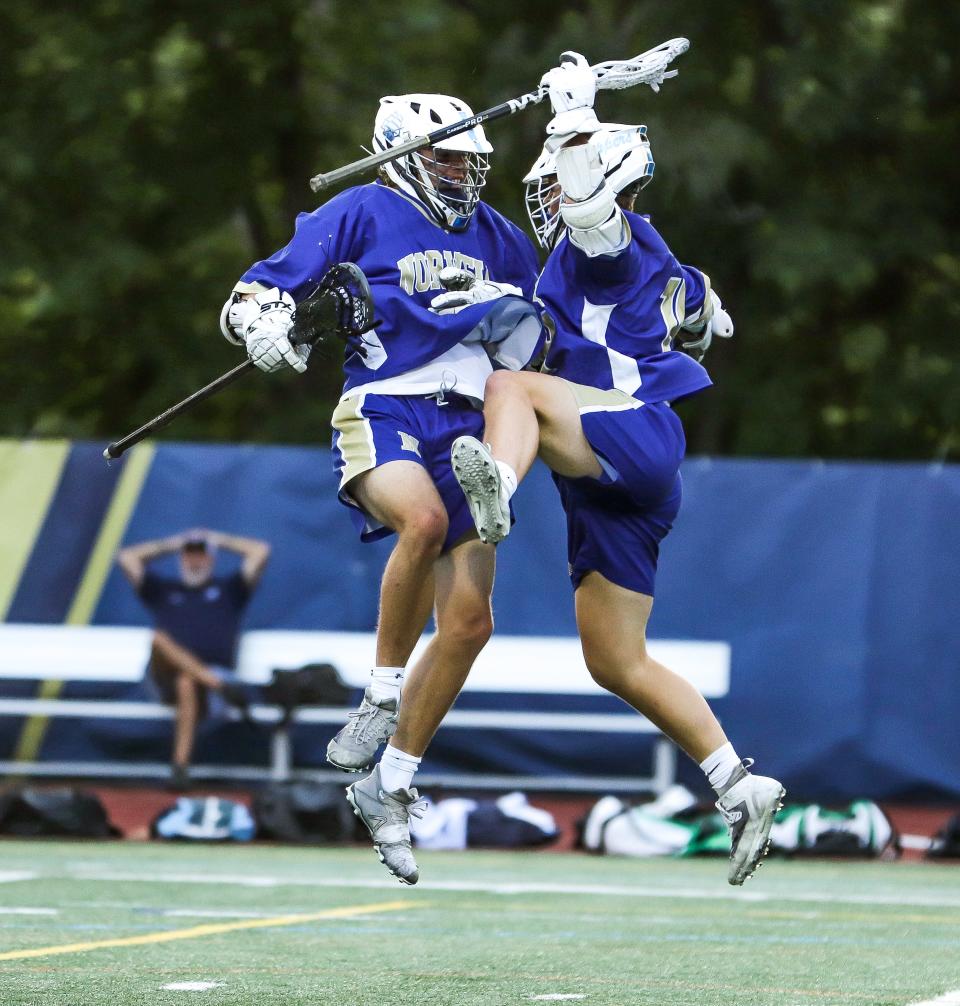 Norwell's Griffin Vetrano, left, celebrates with Ryan Shea after a goal during the Division 3 state title game against Medfield at Worcester State University on Wednesday, June 22, 2022.