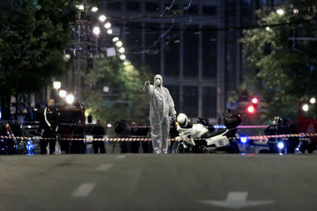 Forensics experts work at the scene after a bomb blast, in central Athens, Greece, April 19, 2017. REUTERS/Alkis Konstantinidis