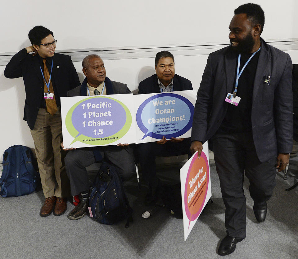 Climate activists from islands in the Pacific Ocean campaign for an ambitious global effort in fighting global warming at a U.N. climate conference in Katowice, Poland, Thursday, Dec. 13, 2018.(AP Photo/Czarek Sokolowski)