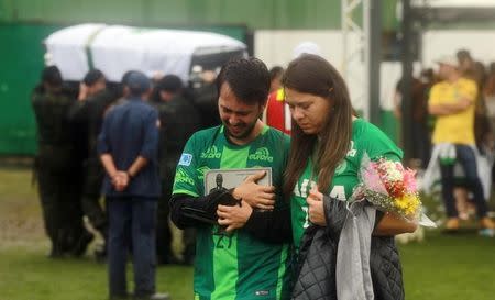 Fans react as the coffin of one of the victims of the plane crash in Colombia is carried into the Arena Conda stadium in Chapeco, Brazil, December 3, 2016. REUTERS/Diego Vara