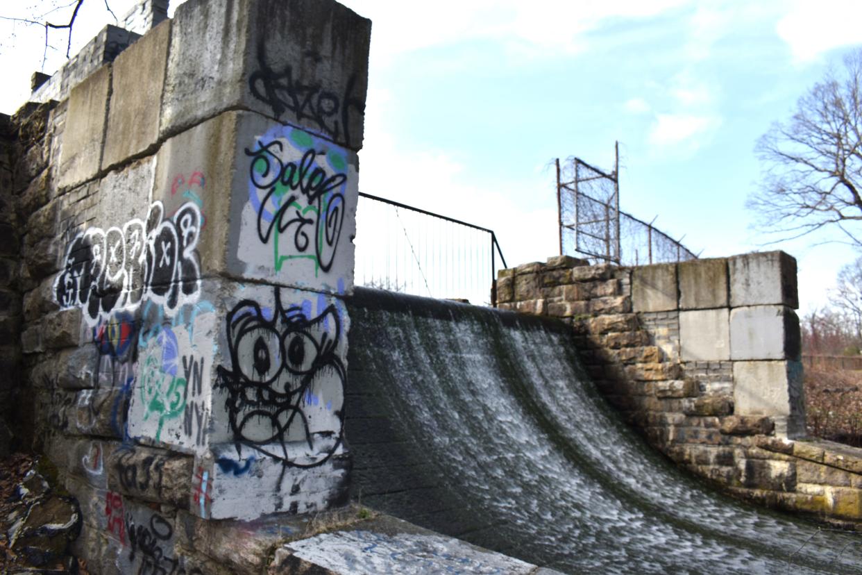 Graffiti is plastered on the spillway of the Lake Isle Dam.