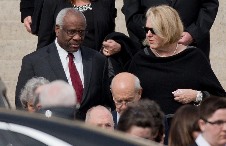Supreme Court Justice Clarence Thomas, left, and his wife Virginia Thomas, right, leave the the Basilica of the National Shrine of the Immaculate Conception in Washington after attending funeral services of the late Supreme Court Associate Justice Antonin Scalia, on Feb. 20, 2016.
