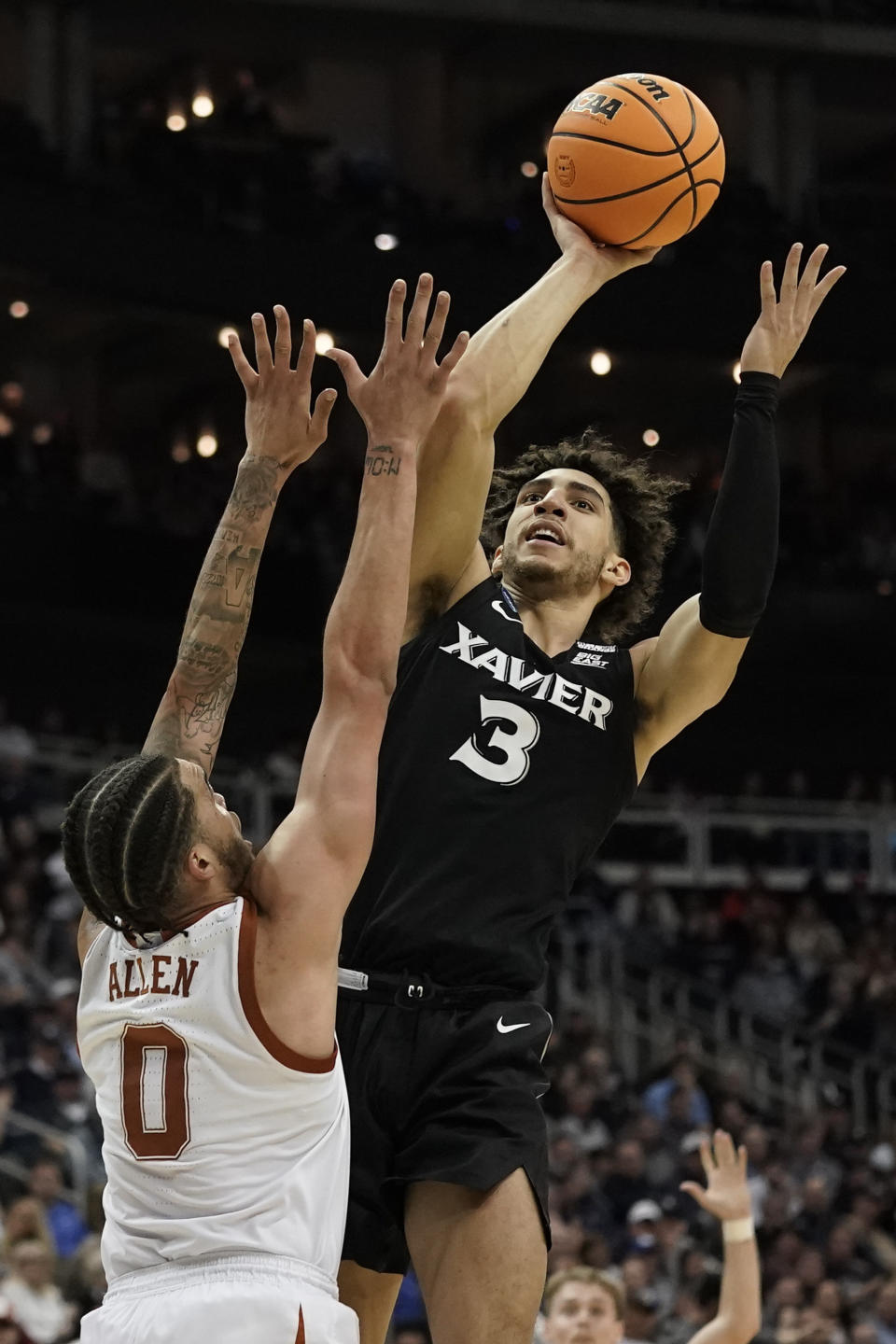 Xavier guard Colby Jones shoots over Texas forward Timmy Alle in the first half of a Sweet 16 college basketball game in the Midwest Regional of the NCAA Tournament Friday, March 24, 2023, in Kansas City, Mo. (AP Photo/Charlie Riedel)