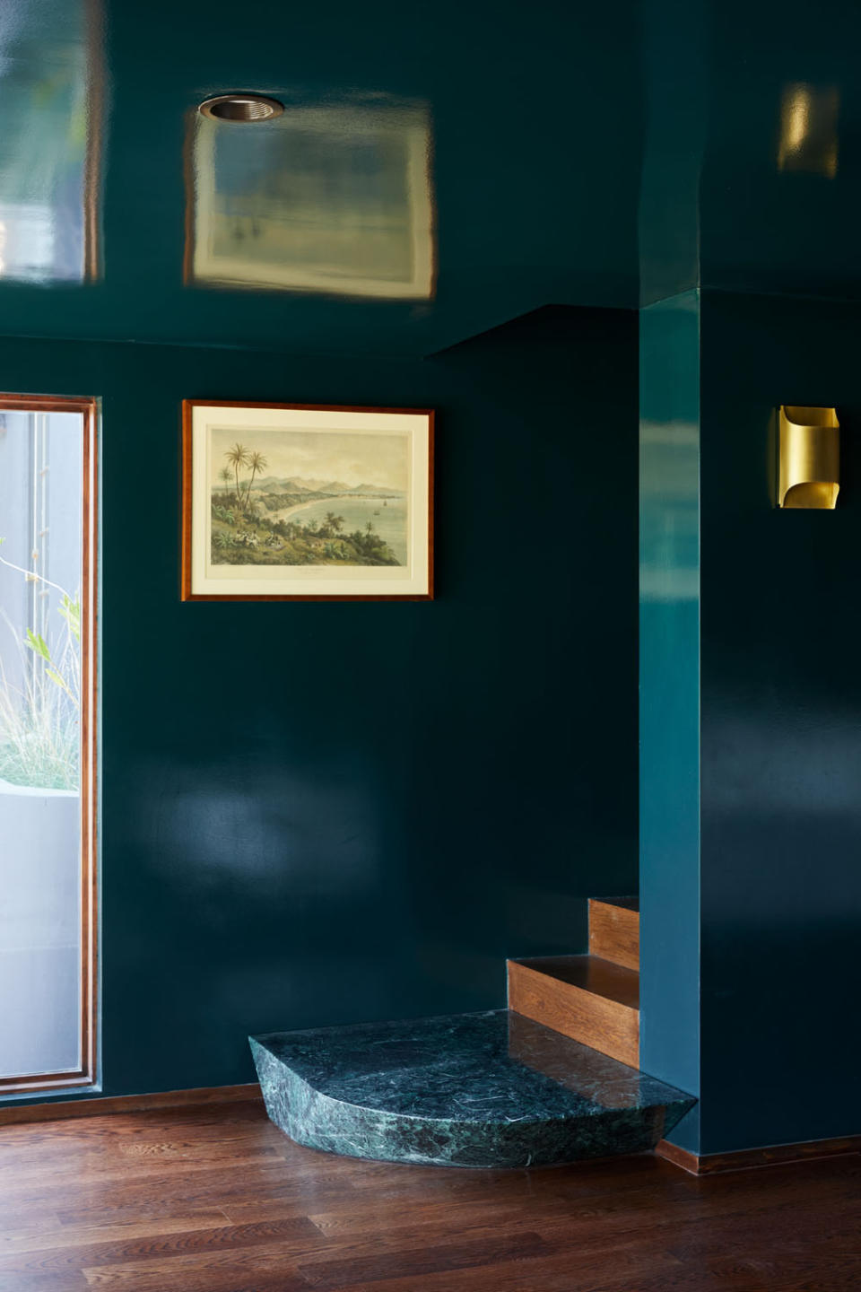 A wooden staircase with a green marble base