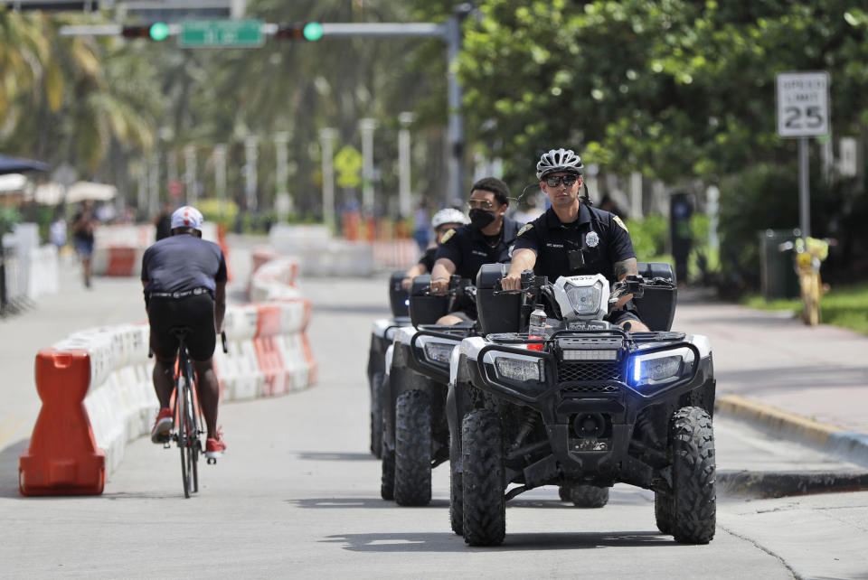 Police officers riding all terrain vehicles patrol Miami Beach, Florida's famed Ocean Drive on South Beach, July 4, 2020. The Fourth of July holiday weekend began Saturday with some sobering numbers in the Sunshine State: Florida logged a record number of people testing positive for the coronavirus. (AP Photo/Wilfredo Lee)