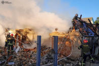 In this photo provided by the Ukrainian Emergency Service, rescuers work at a damaged building after a Russian missile attack in Kyiv region, Ukraine, Wednesday, May 8, 2024. (Ukrainian Emergency Service via AP Photo)