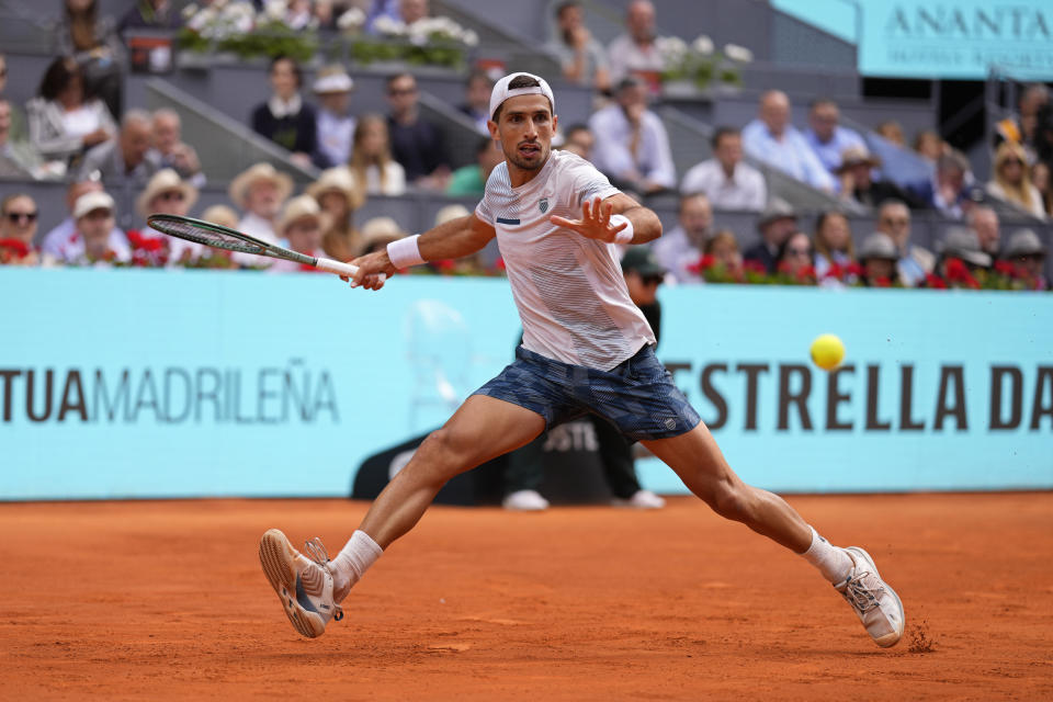 Pedro Cachin of Argentina returns the ball to Rafael Nadal of Spain during the Mutua Madrid Open tennis tournament in Madrid, Spain, Monday, April 29, 2024. (AP Photo/Manu Fernandez)