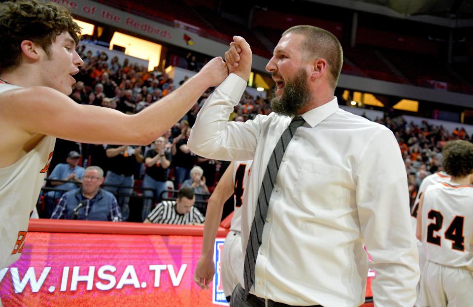 Roanoke-Benson head coach Abe Zeller fist-bumps his players after their 45-43 victory over Chicago Fenger in a Class 1A supersectional Tuesday, March 10, 2020 at Redbird Arena in Normal.