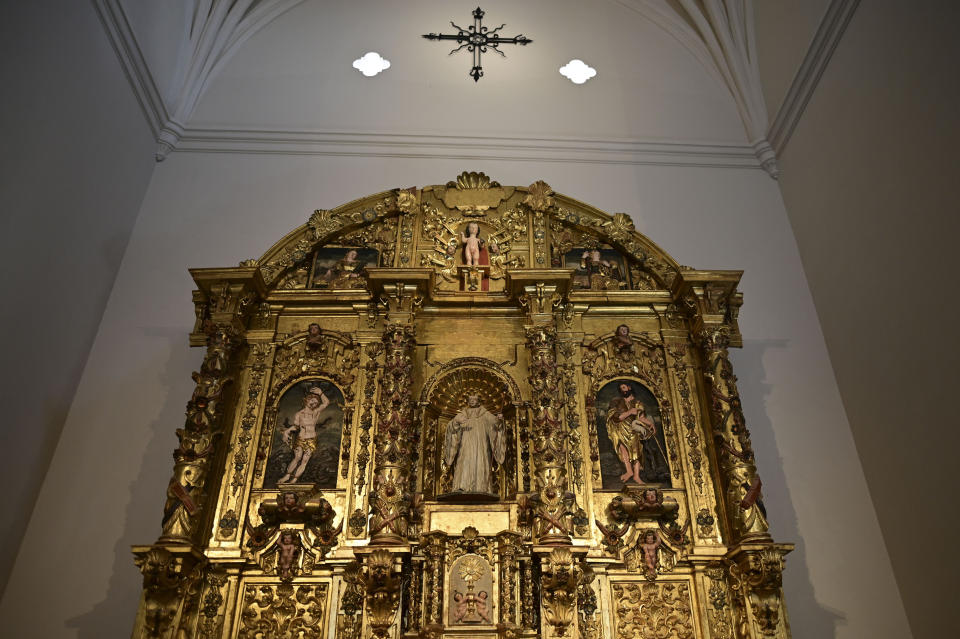 An altarpiece shows religious figures inside the second oldest Spanish church in the Americas, the San Jose Church, that will reopen following a massive reconstruction that took nearly two decades to complete in San Juan, Puerto Rico, Tuesday, March 9, 2021. All the figures depicted on the church’s gilded altar have been identified except for one: a woman with flaxen hair in the upper left-hand corner holding a palm frond, which indicates she was a martyr but offers no other clues. (AP Photo/Carlos Giusti)