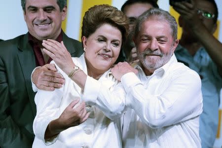 Former president Luiz Inacio Lula da Silva congratulates Brazil's President and Workers' Party (PT) presidential candidate Dilma Rousseff (L) during news conference after disclosure of the election results, in Brasilia October 26, 2014. REUTERS/Ueslei Marcelino