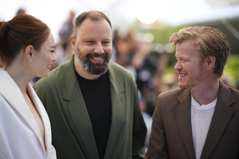 Emma Stone, from left, director Yorgos Lanthimos, and Jesse Plemons pose for photographers at the photo call for the film 'Kinds of Kindness' at the 77th international film festival, Cannes, southern France, Saturday, May 18, 2024. (Photo by Daniel Cole/Invision/AP)
