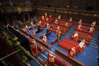 Members stand in the House of Lords in the Palace of Westminster, London, for the arrival of Queen Elizabeth II at the State Opening of Parliment, Tuesday May 11, 2021. (Aaron Chown/Pool via AP)