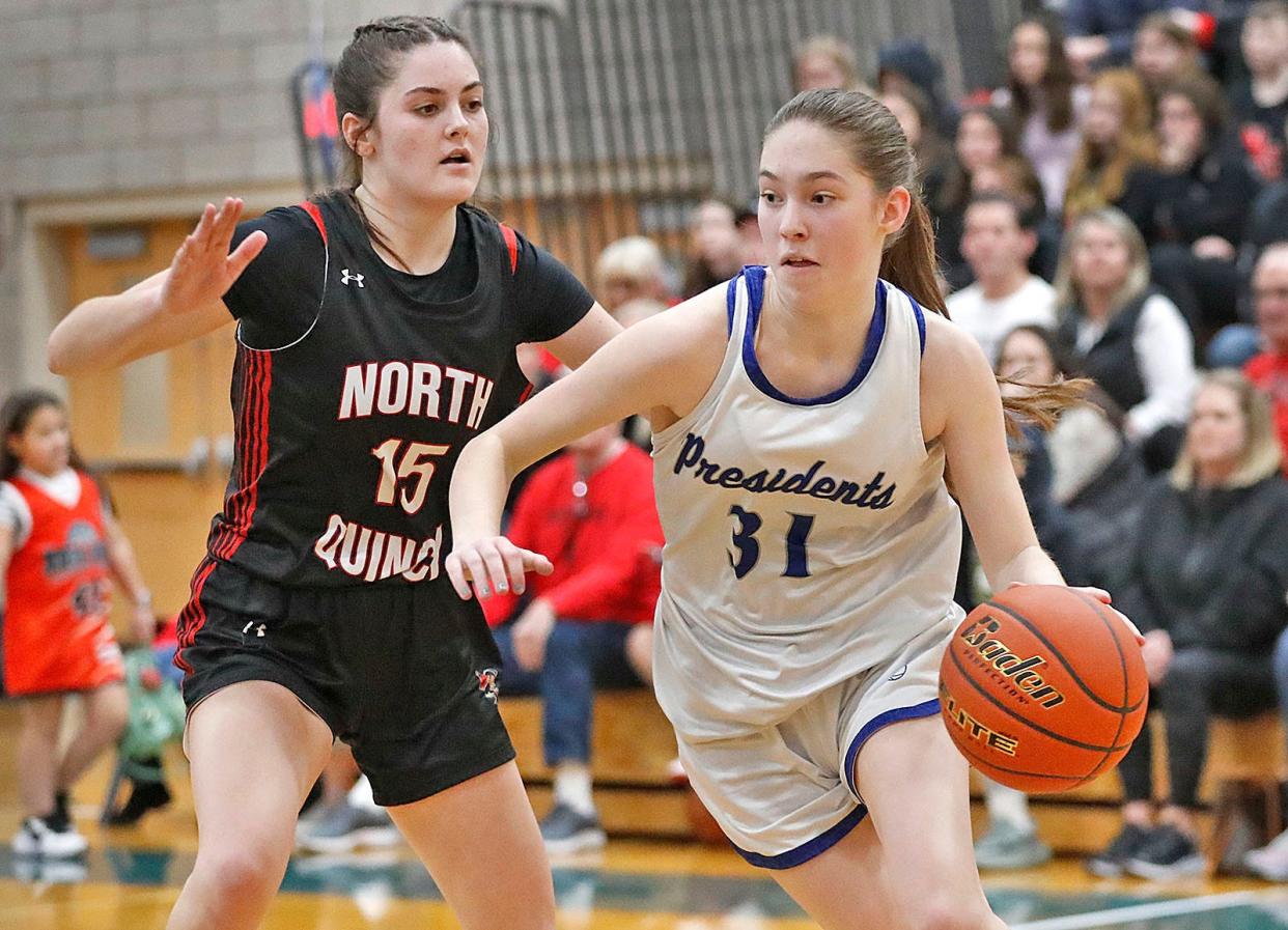 President #31 Paige Mann makes a cut toward the basket, passing North's #15 Ava Bryan.

The Quincy High girls basketball hosts North Quincy High on Friday Feb. 9, 2024