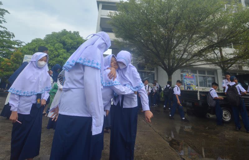 Students gather at an open area following an earthquake in Padang