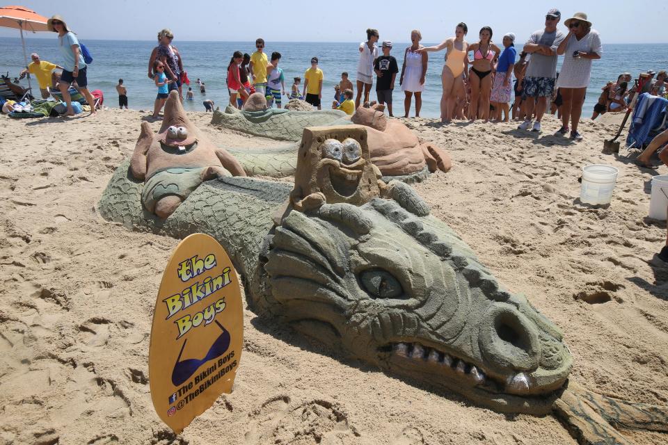 The Bikini Boys of Seaside Heights complete their "SpongeBob's 20th Anniversary Riding on a Sea Serpent" sand sculpture during the 33rd annual New Jersey Sandcastle Contest on the 18th Avenue Beach in Belmar, NJ Wednesday July 17, 2019.