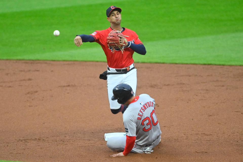 Guardians shortstop Brayan Rocchio turns a double play as Boston Red Sox right fielder Rob Refsnyder slides in the second inning, April 23, 2024, in Cleveland.