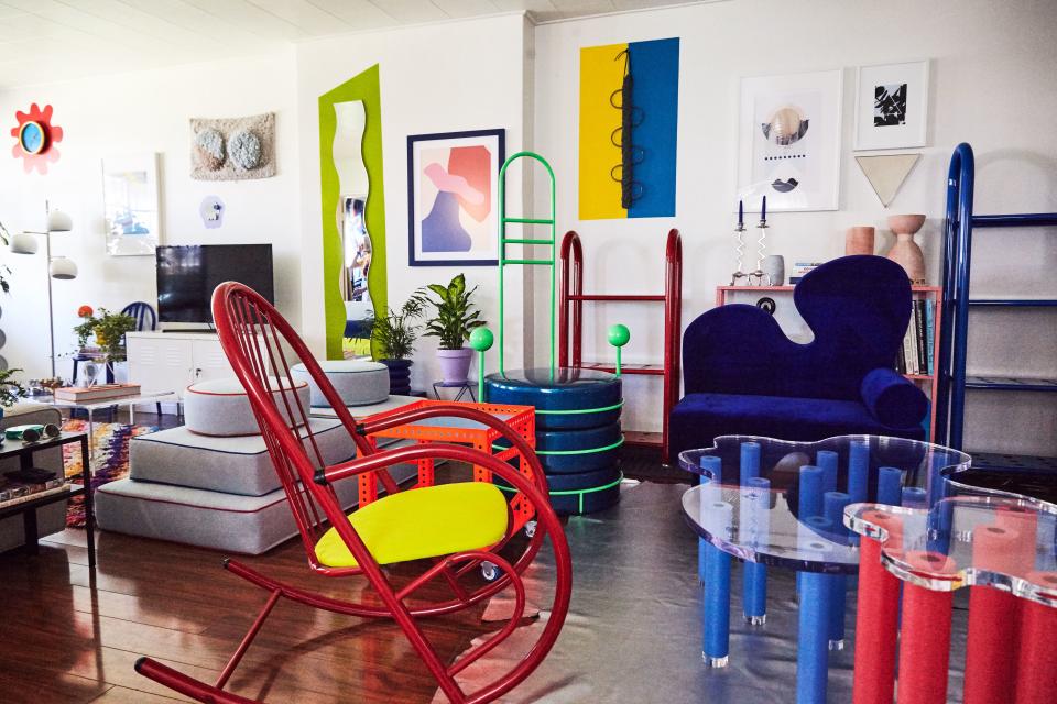 A vintage rocking chair from Etsy, reupholstered with lime green denim, connects Leah’s curated furniture with her own designs, seen on the right: the Zorg Chair, the Pool Table, the Jacuzzi Table, the small Tubular Bookshelf, the large Tubular Bookshelf, the Stacks Bench, and the Bordon Chair.