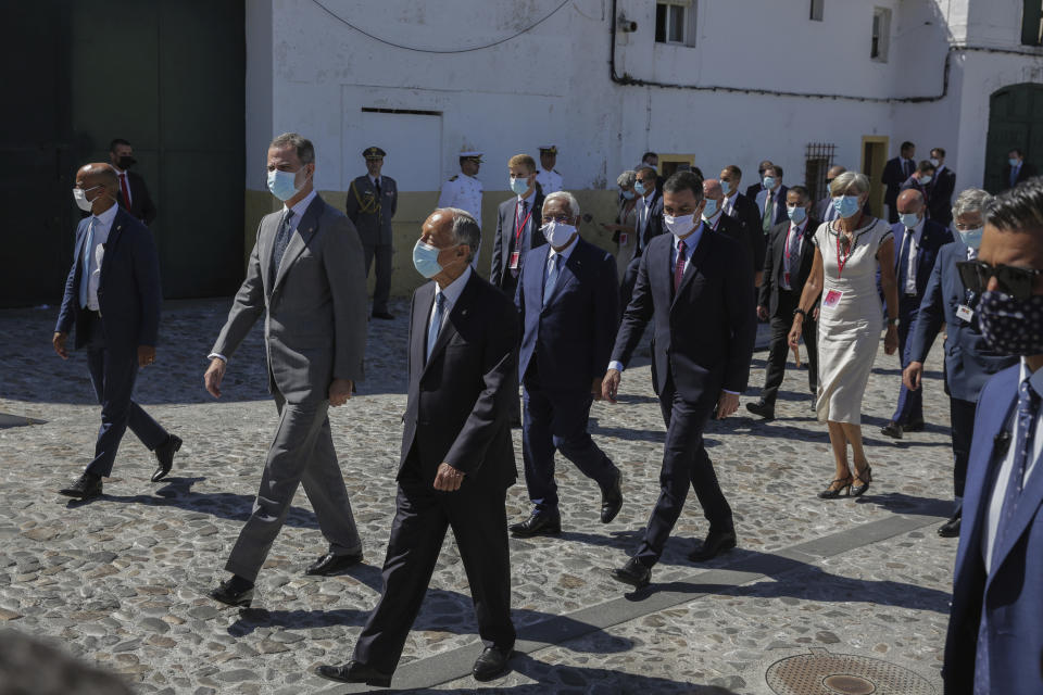 Spain's King Felipe VI, Portugal's President Marcelo Rebelo de Sousa, foreground, Portugal's Prime Minister Antonio Costa and Spain's Prime Minister Pedro Sanchez, background, walk during a ceremony to mark the reopening of the Portugal/Spain border in Elvas, Portugal, Wednesday, July 1, 2020. The border was closed for three and a half months due to the coronavirus pandemic. (AP Photo/Armando Franca)