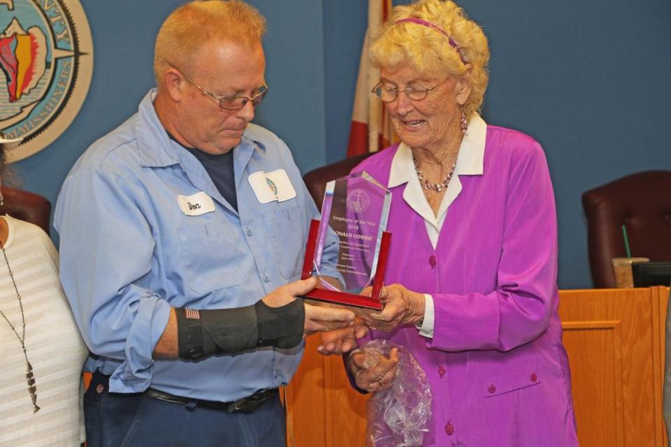 Monroe County Commissioner Sylvia Murphy presents the 2018 Employee of the Year award to Donald Lowrie. Lowrie was also awarded the prestigious Carnegie Medal for his efforts in saving a girl from two dogs that were attacking her.