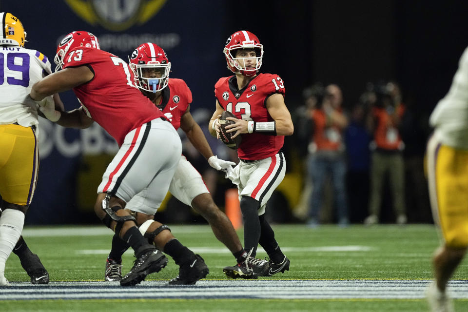 Georgia quarterback Stetson Bennett (13) looks for an open receiver in the first half of the Southeastern Conference Championship football game against the LSU Saturday, Dec. 3, 2022 in Atlanta. (AP Photo/John Bazemore)