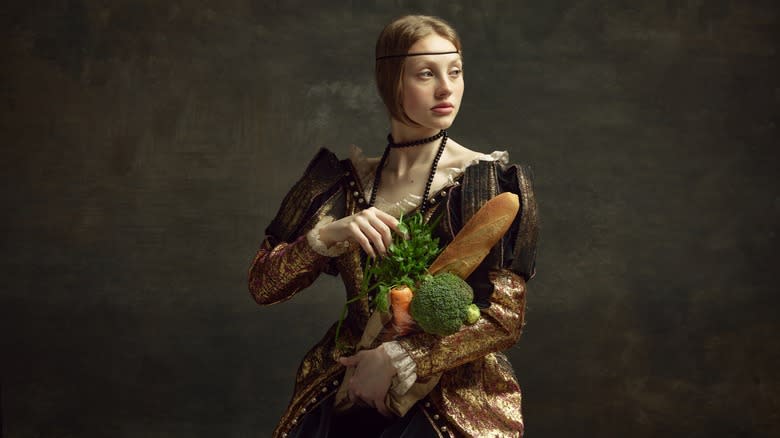 Medieval nobility holding food