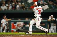 Baltimore Orioles' Cedric Mullins singles against the Texas Rangers during the eighth inning of a baseball game, Tuesday, July 5, 2022, in Baltimore. The Orioles won 10-9 in ten innings. (AP Photo/Julio Cortez)