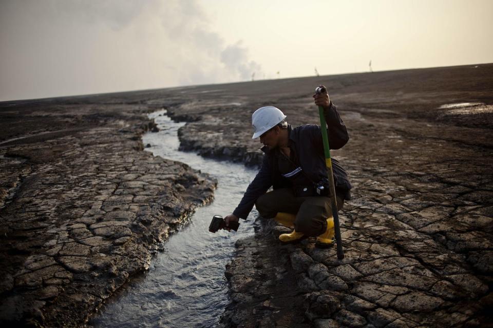 An officer of the Sidoarjo Mud Prevention Agency checks the water temperature of mud near the Lusi mud volcano in 2011. <a href="https://www.gettyimages.com/detail/news-photo/an-officer-of-indonesian-agency-sidoarjo-mud-prevention-news-photo/114923592" rel="nofollow noopener" target="_blank" data-ylk="slk:Ulet Ifansasti/Getty Images;elm:context_link;itc:0;sec:content-canvas" class="link ">Ulet Ifansasti/Getty Images</a>