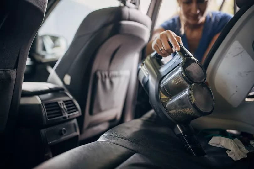 Cleaning car with cordless stick vacuum cleaner