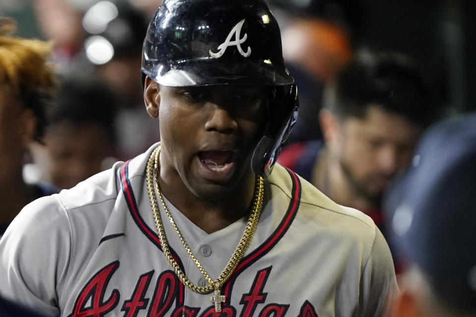 Atlanta Braves' Jorge Soler celebrates in the dugout after a three-run home run during the third inning in Game 6 of baseball's World Series between the Houston Astros and the Atlanta Braves Tuesday, Nov. 2, 2021, in Houston. (AP Photo/David J. Phillip)