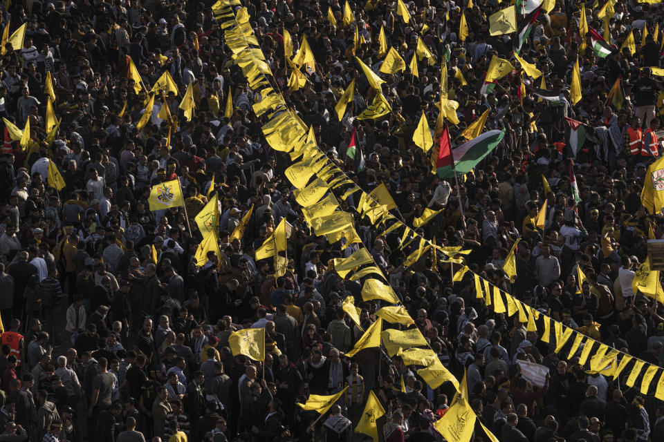 Palestinians wave yellow Fatah movement flags during a rally marking the 18th anniversary of the death of Fatah founder and Palestinian Authority leader Yasser Arafat in Gaza City, Thursday, Nov. 10, 2022. (AP Photo/Fatima Shbair)